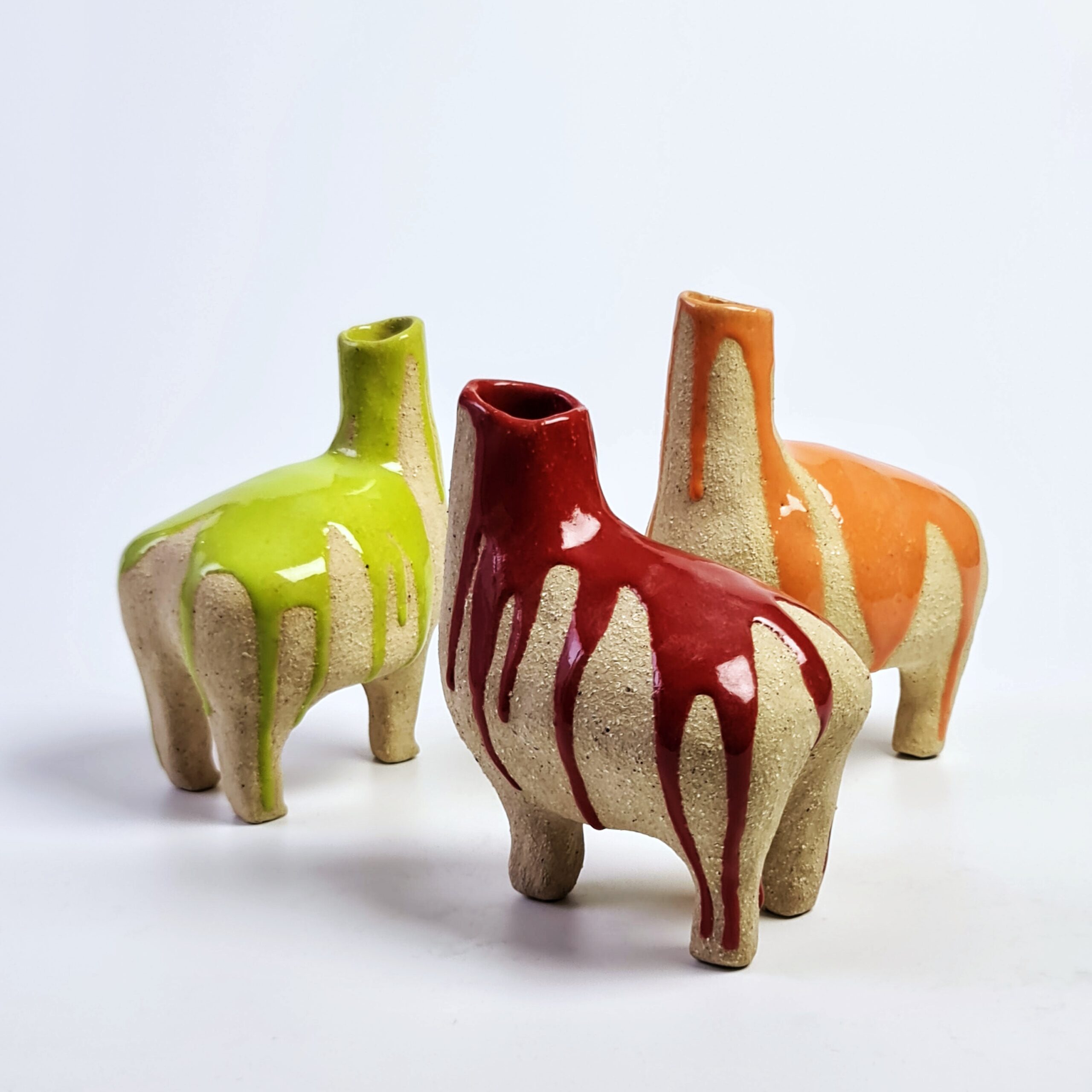 3 ceramic headless llamas in varying colours